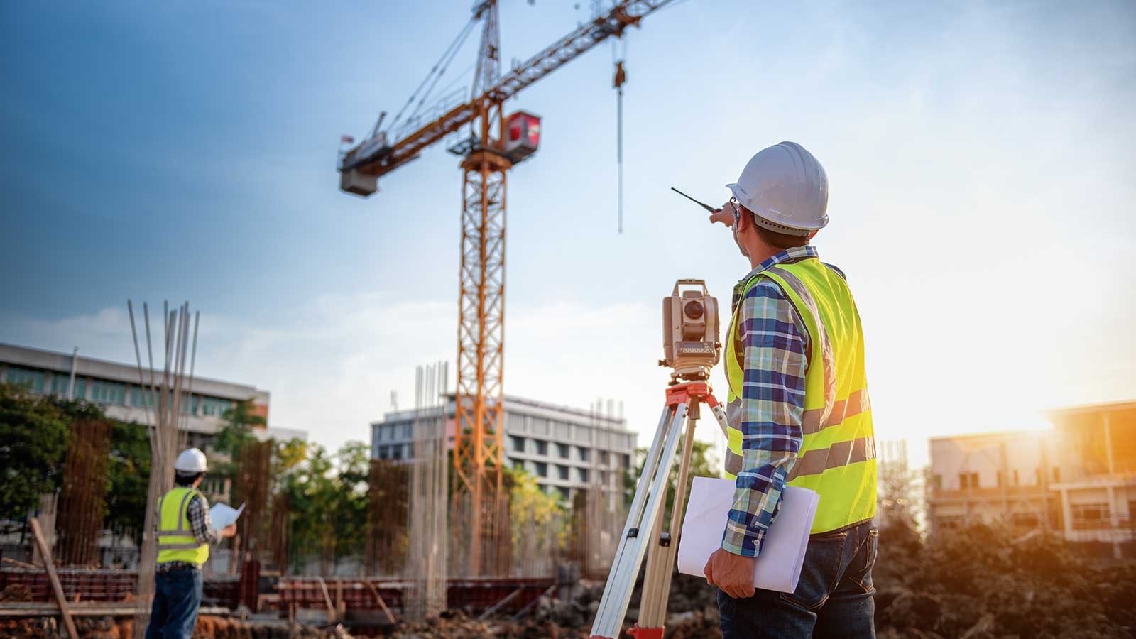 An engineering taking measurements on a construction site