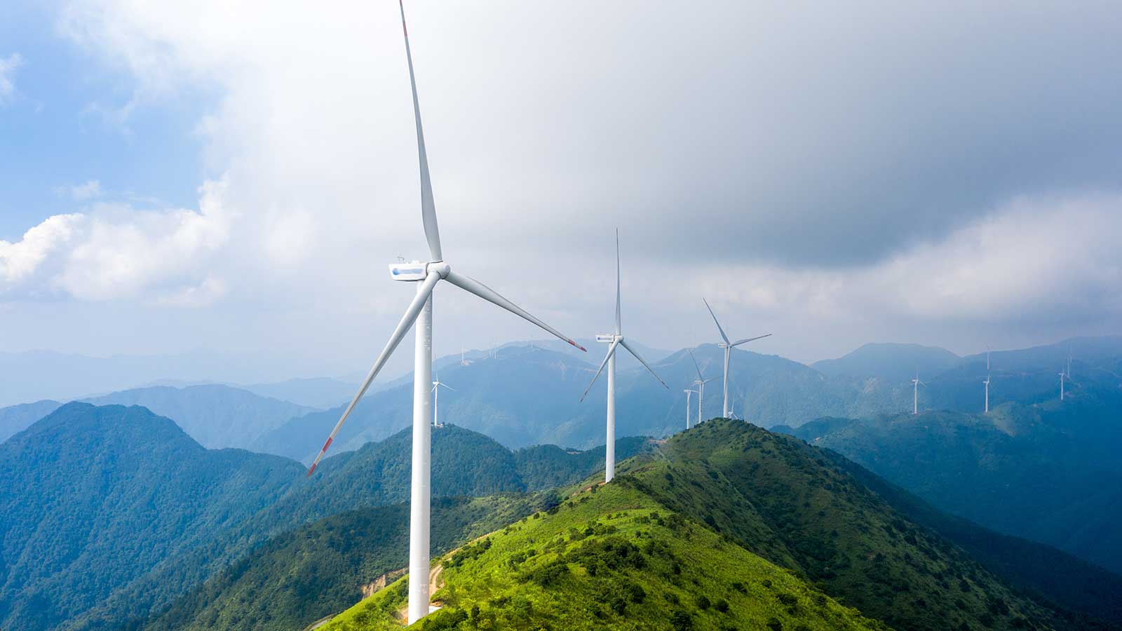 Wind turbines on hilltops representing Business Energy Advanced Certificates at Clarkson University