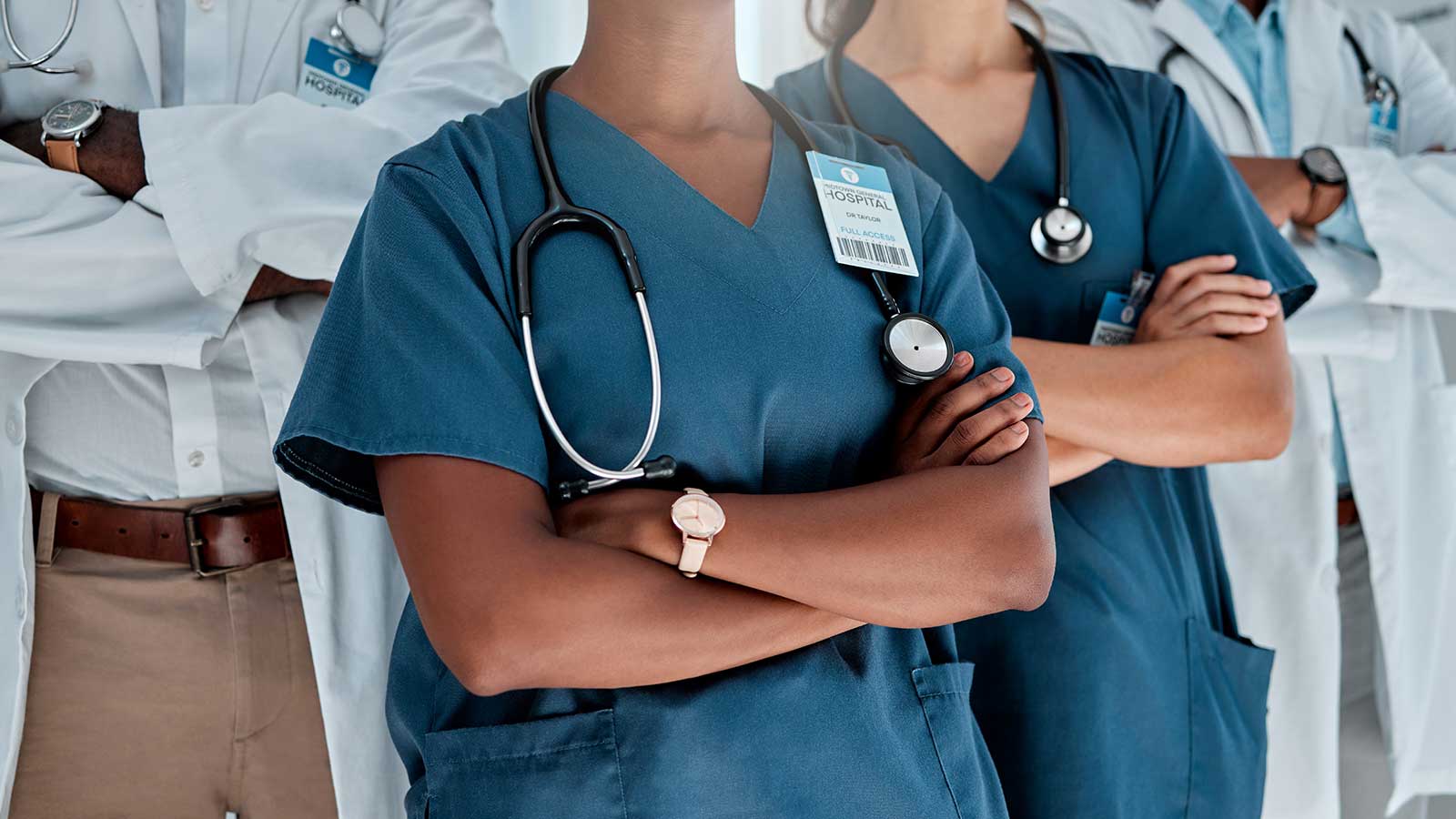 Medical professionals standing together with crossed arms