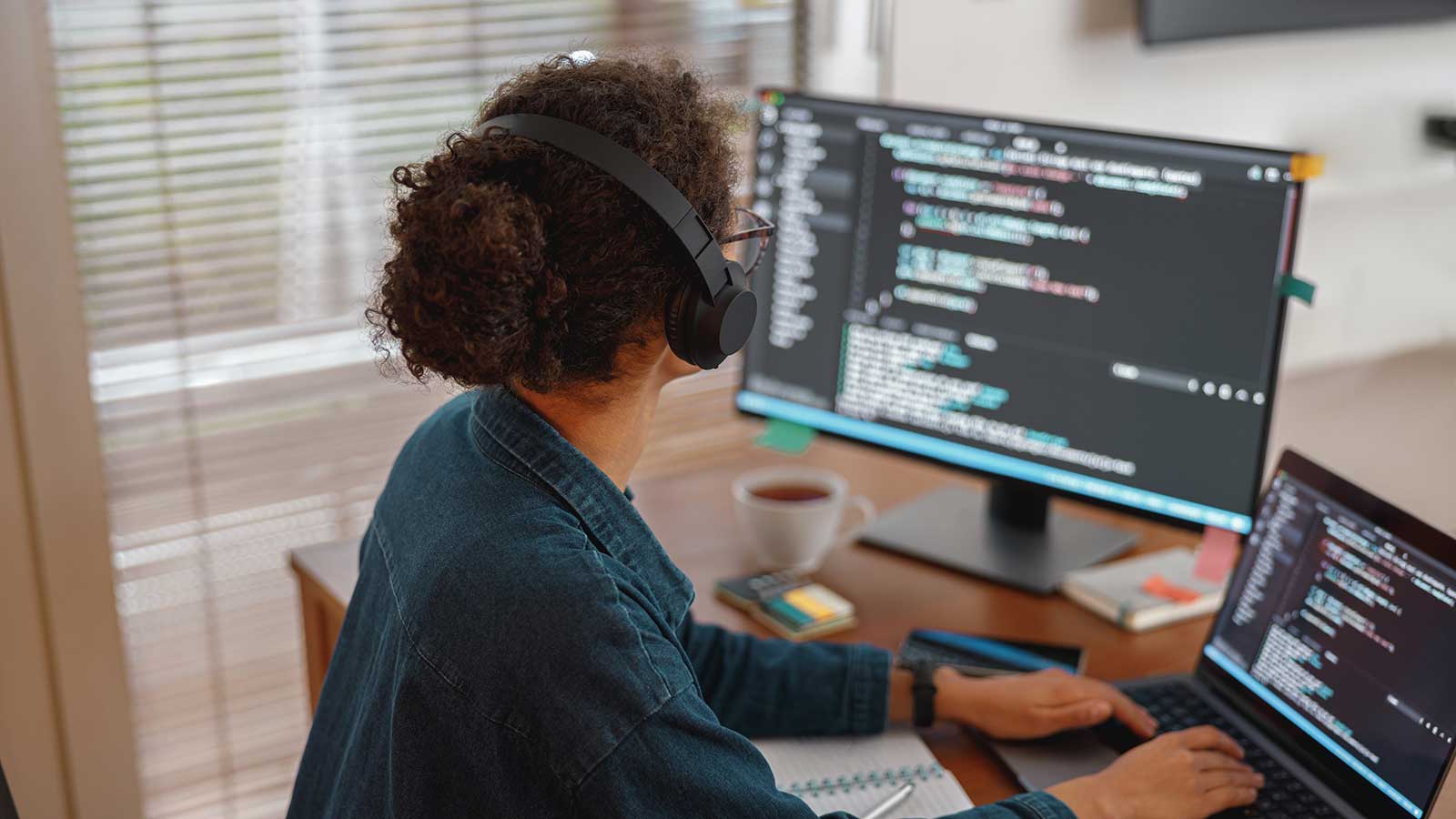 Student looking at code on two monitors representing Computer Science programs at Clarkson University