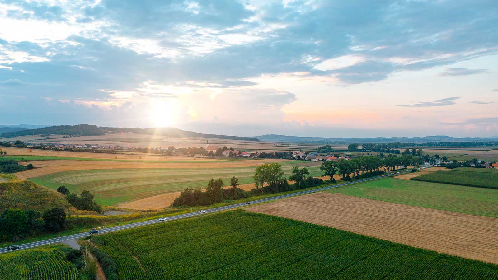 sunrise over agricultural fields representing Environmental Policy studies at Clarkson University