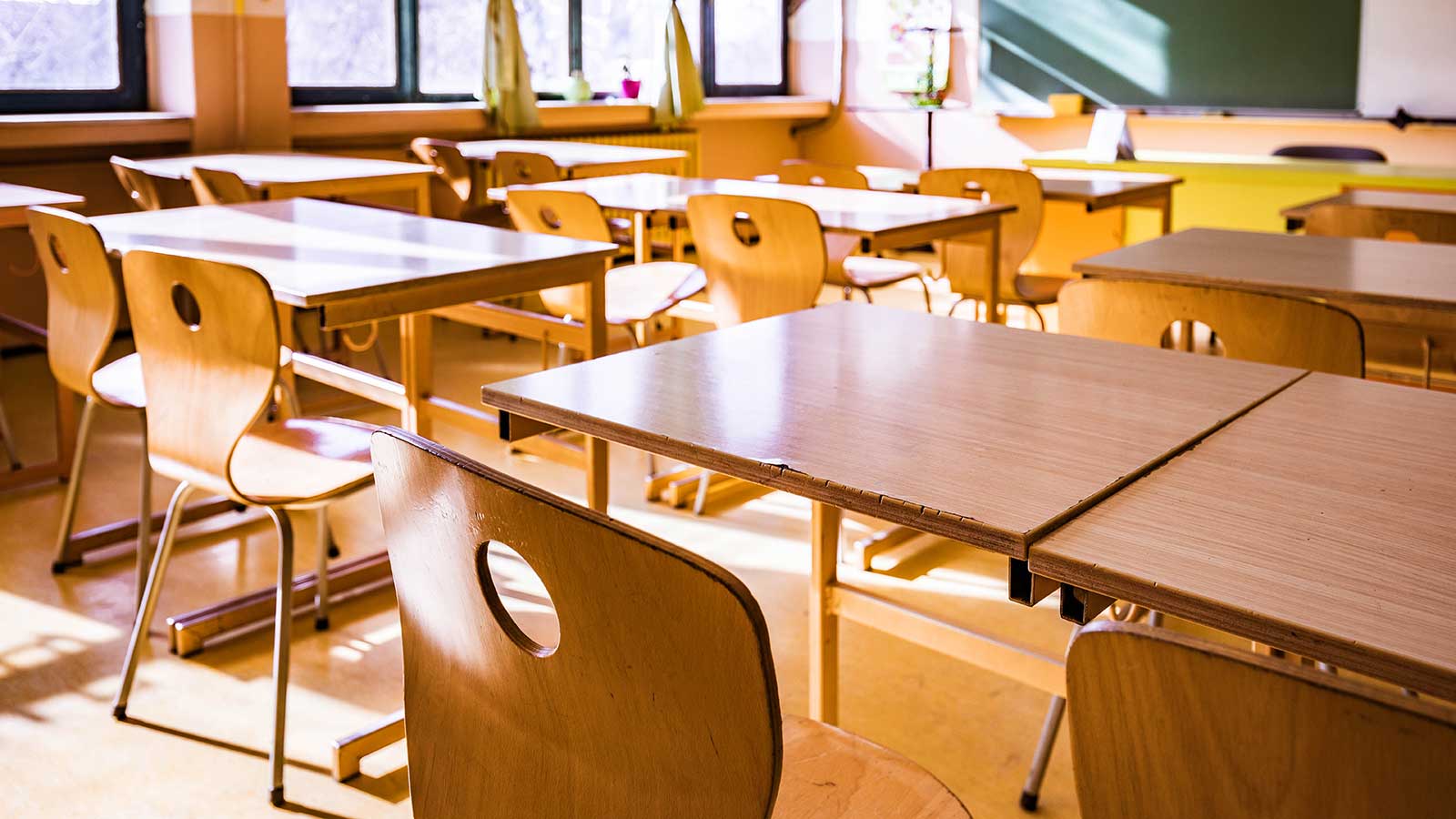 wooden desks and chairs representing the Master of Arts in Curriculum Instruction at Clarkson University