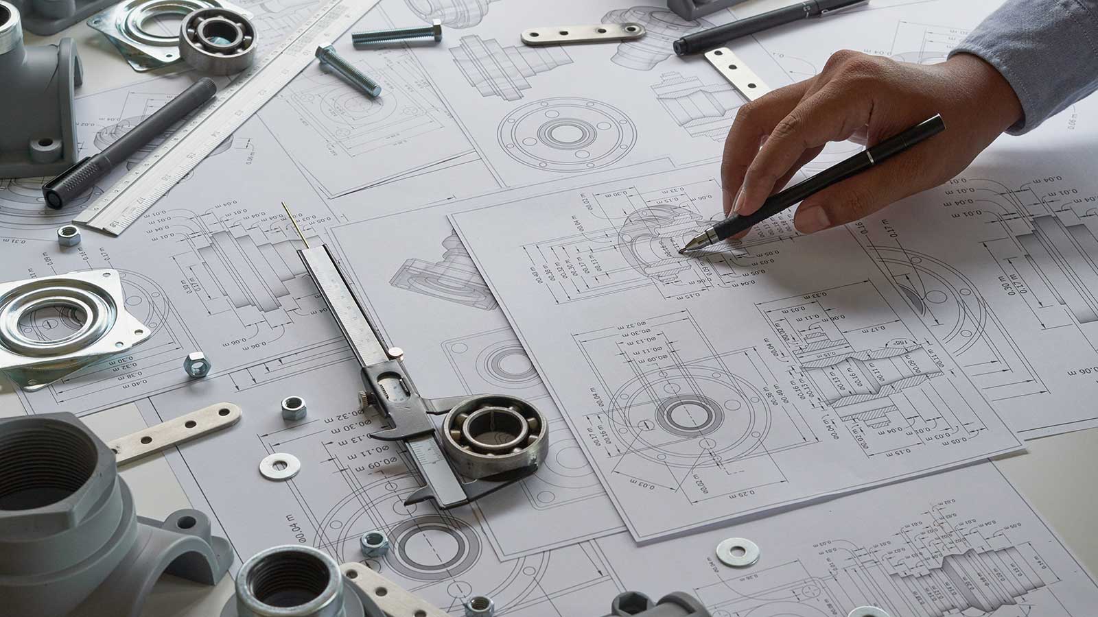 Mechanical engineer looking at blueprints representing mechanical engineering program at Clarkson university 