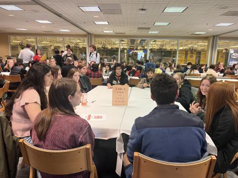 students are seated around a table at STARTScience@Clarkson.