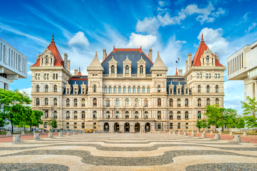 The Albany NY capitol building under blue sky.