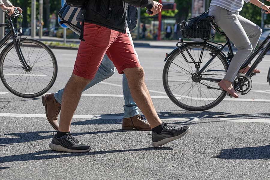 People biking and walking on crosswalk