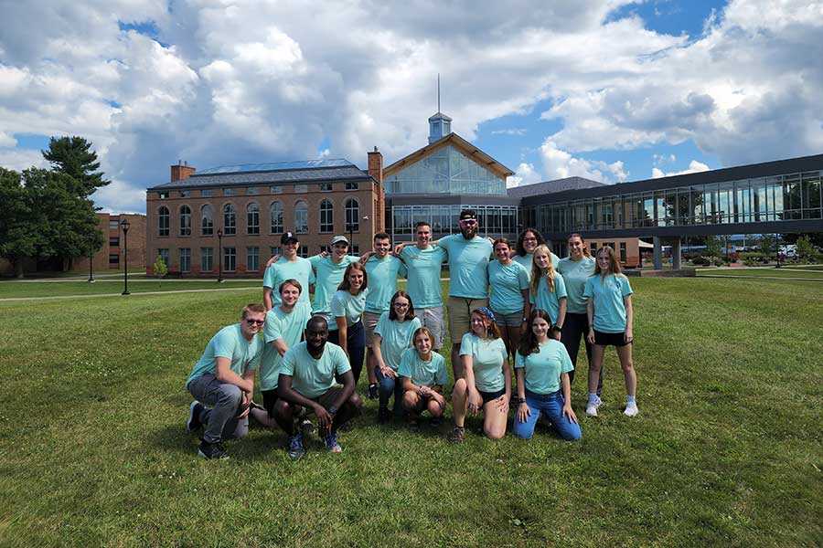 Group of students dressed in matching shirts on the Cheel lawn