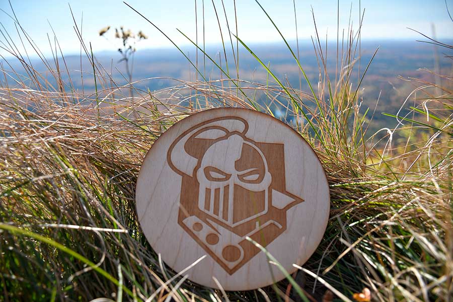 Coaster with Clarkson logo on it in the grass