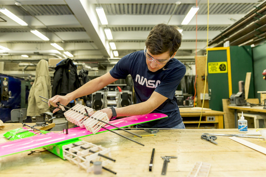 Design build fly project student working on model.