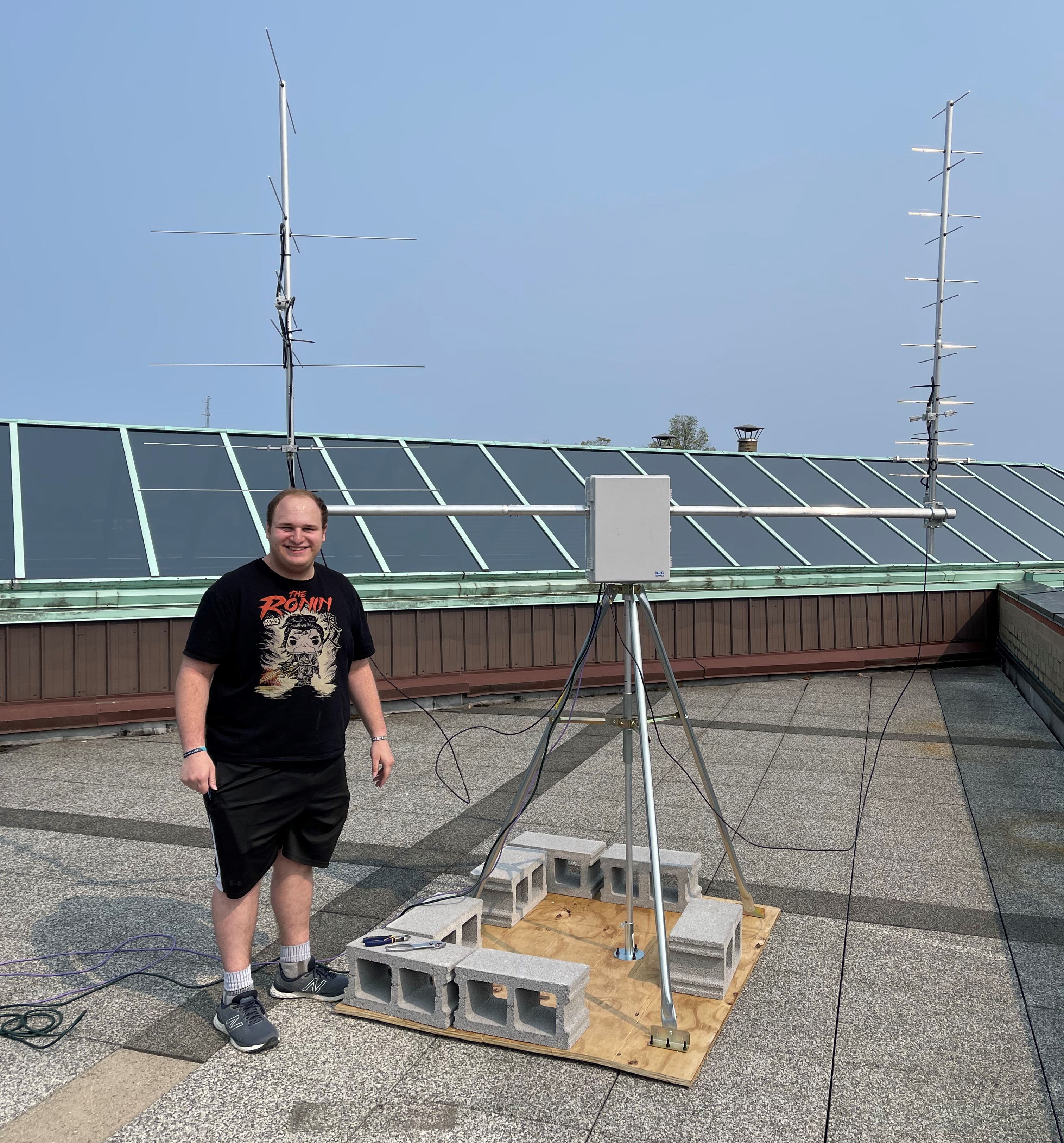 Michael Buchwald stands next to his low-cost university ground station
