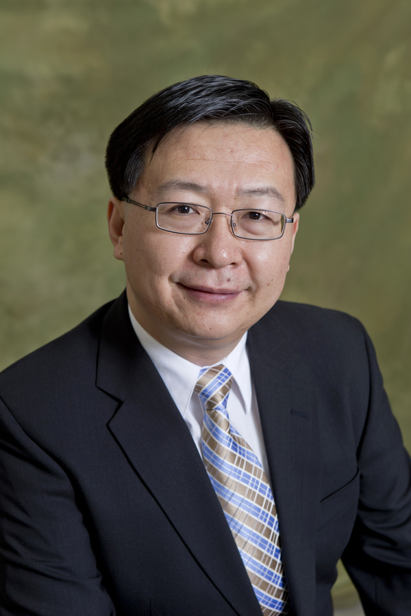 A headshot of Dennis Yu smiling.