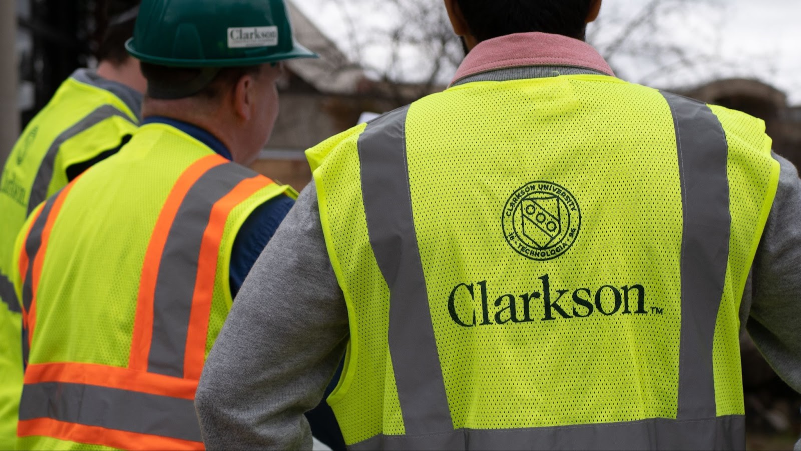 Clarkson University logo on the back of a high-visibility vest being worn by a Clarkson student