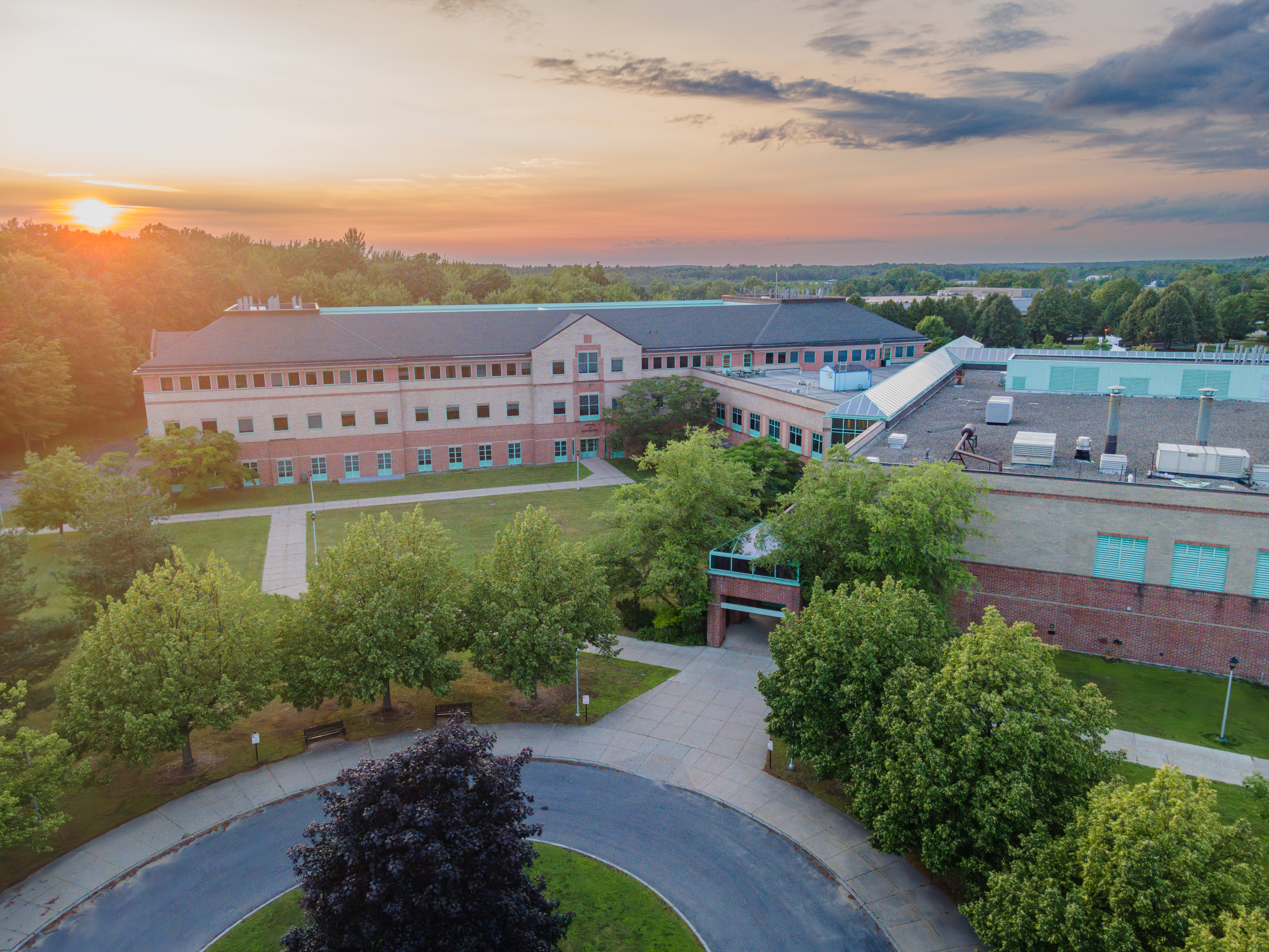 Summer aerial photo of the Center for Advanced Materials Processing (CAMP) with a sunset view in the background.