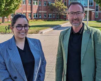 Imane Magrez  (left) and Christian Felzensztein (right) standing outside in front of Bertrand H. Snell Hall.