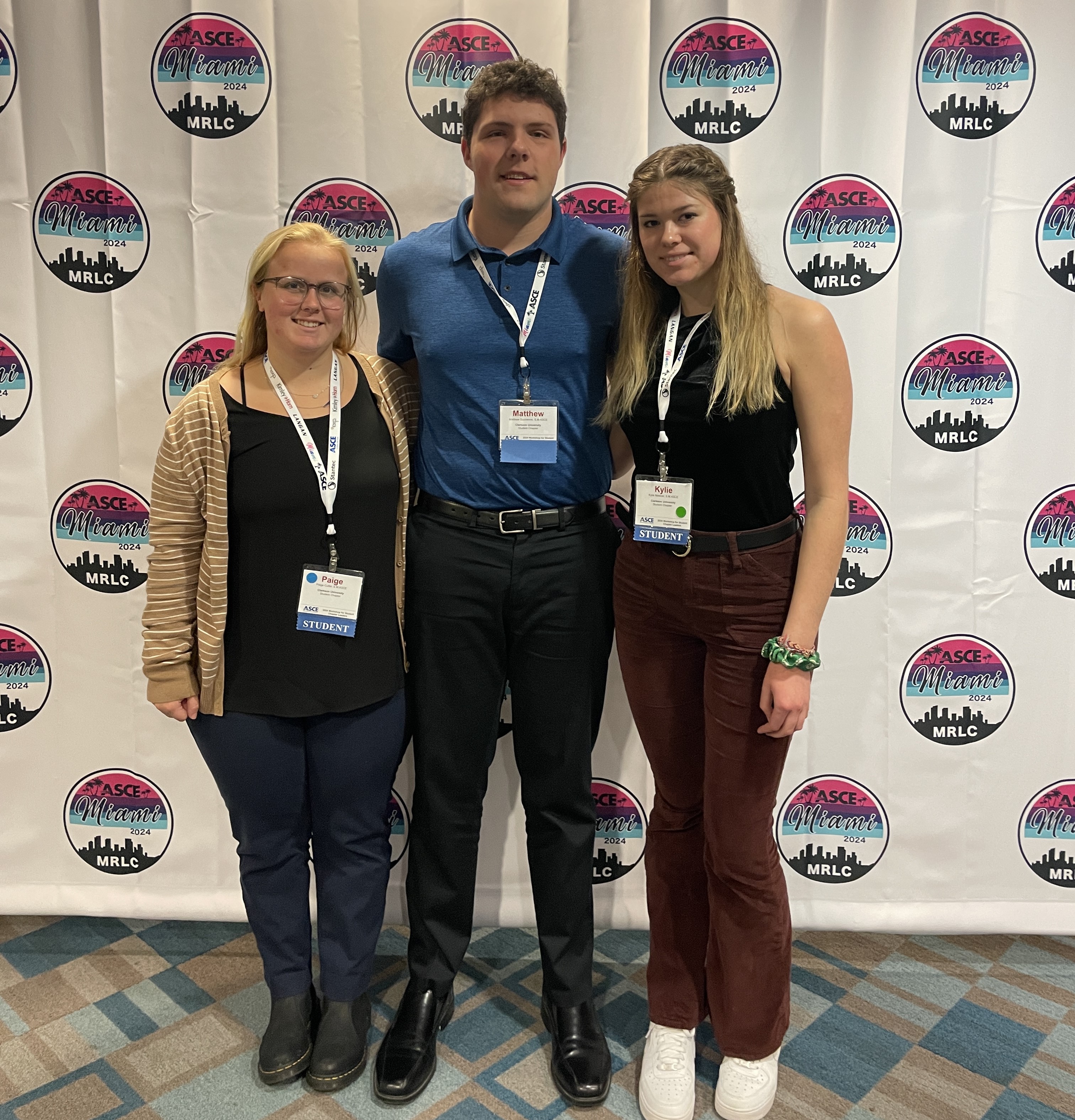 Matthew Ducharme ‘25, Kylie Nowicki ‘25, and Paige Cutler ‘25, pose for a photo together in front of a backdrop at the American Society of Civil Engineers Workshop for Student Leaders
