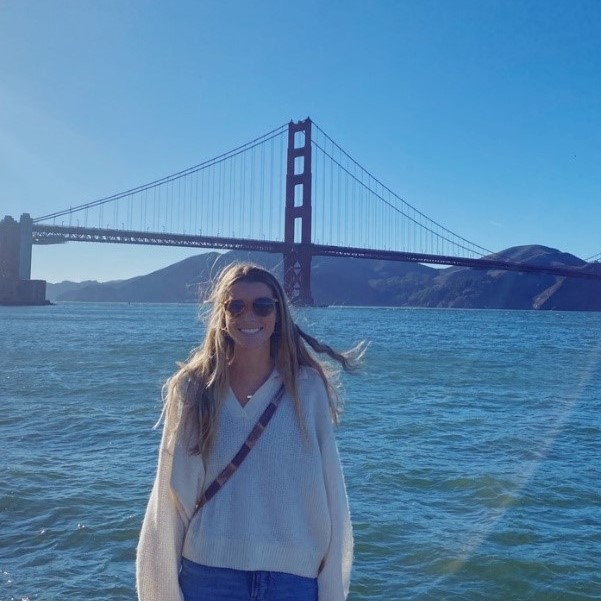 Mackenzie Dalton smiling in front of a bridge