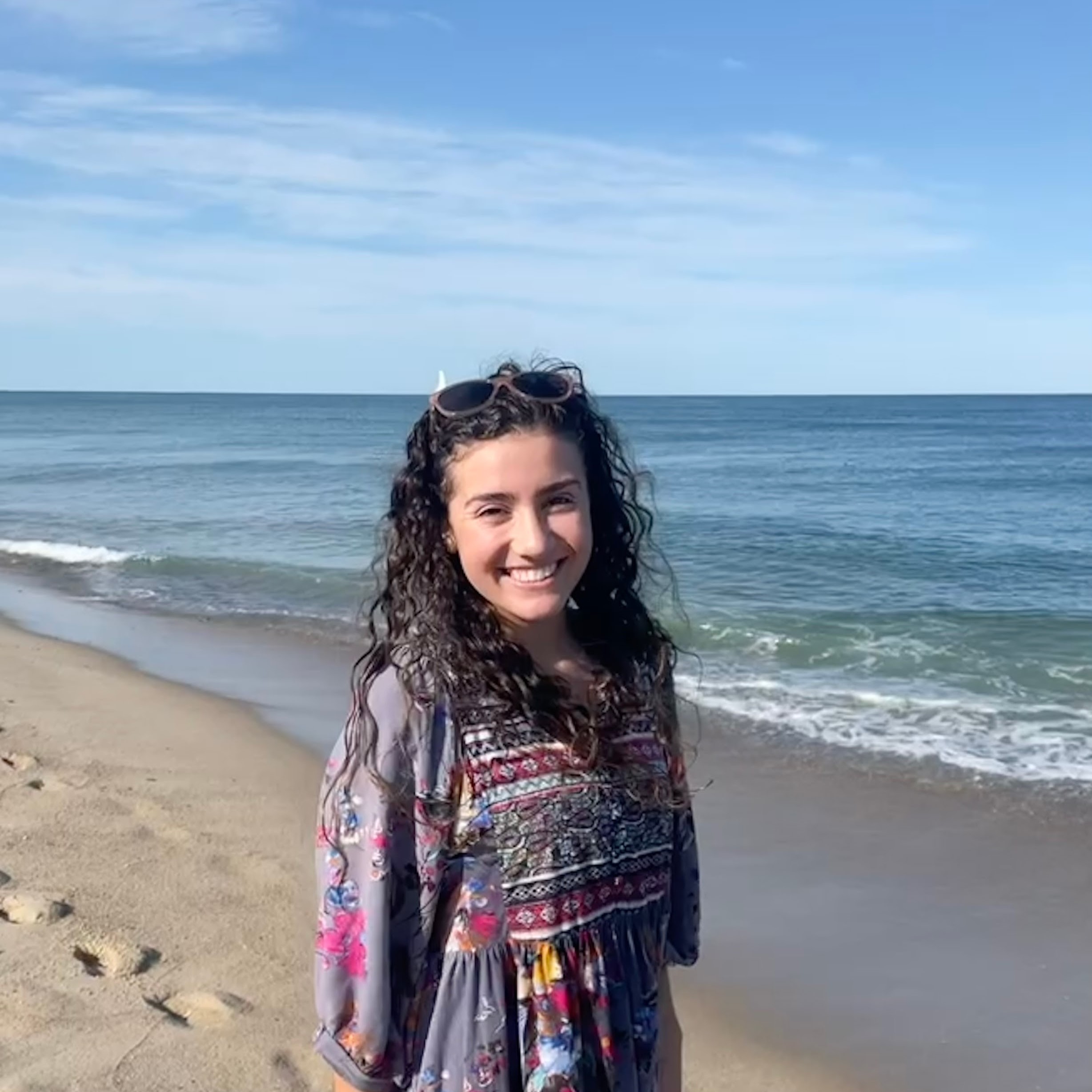 Gianna Capoccia standing on the shore of a beach.