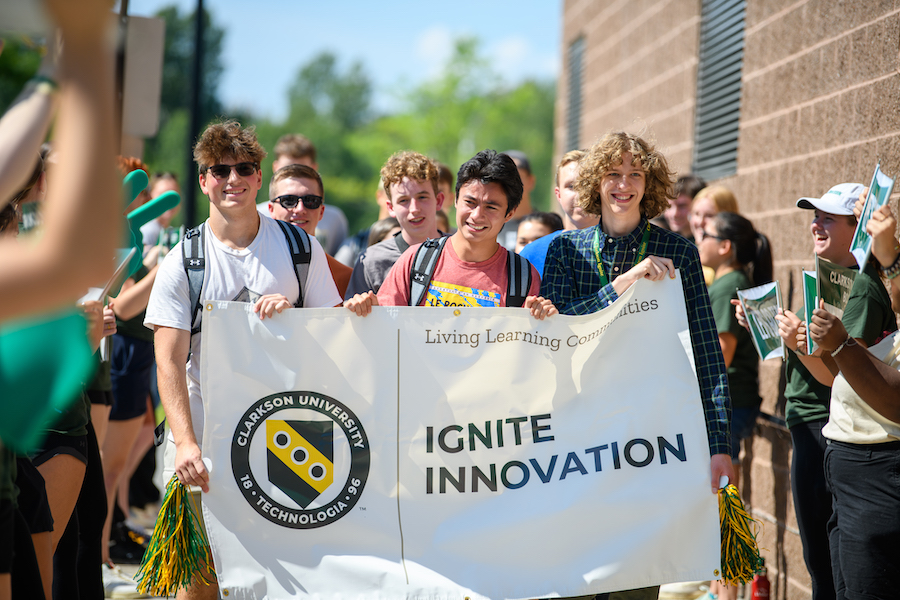 Students carrying a banner promoting Clarkson Ignite