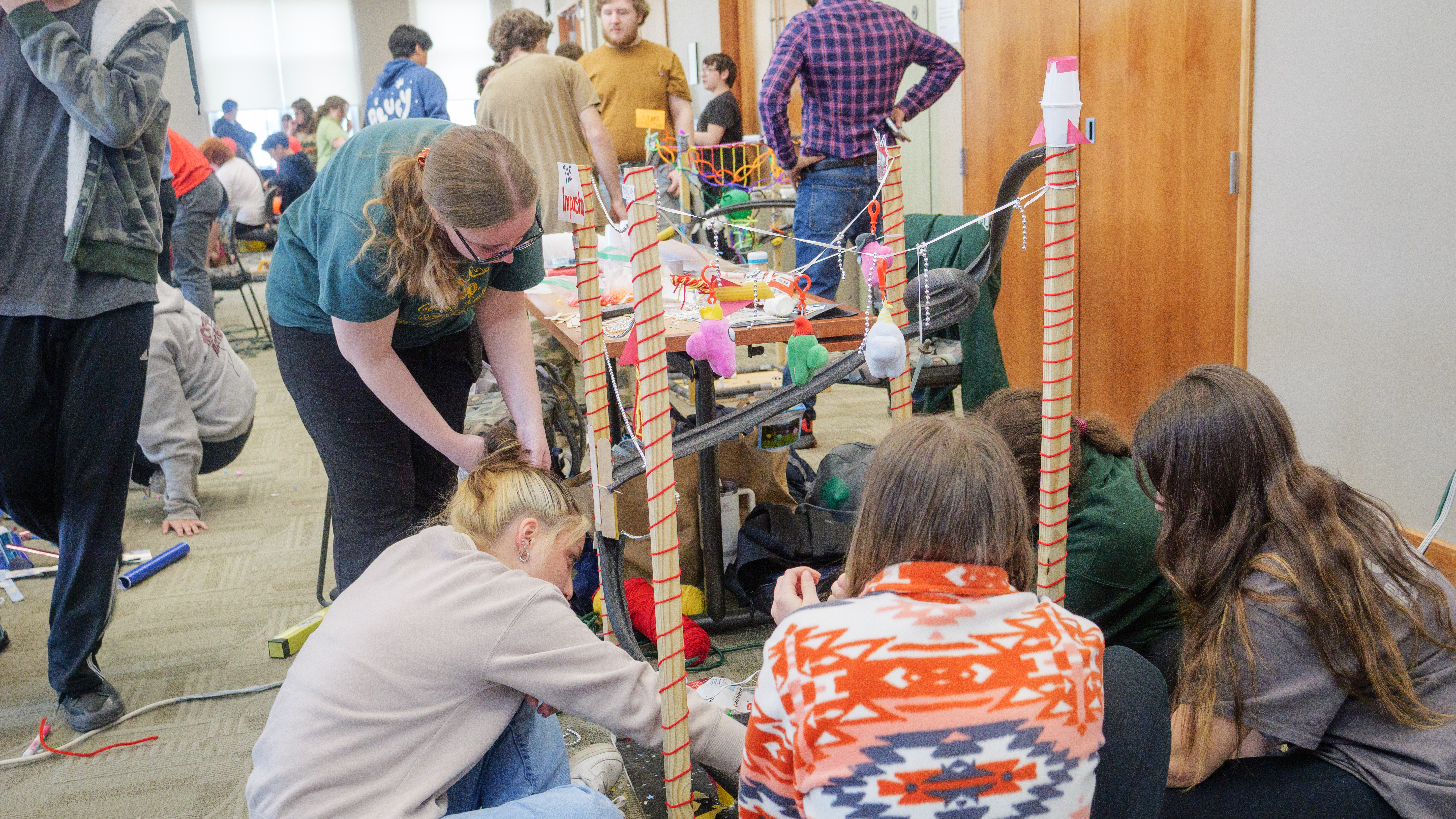 Several students work on a model roller coaster