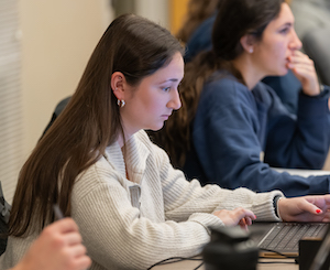 A Clarkson University student studies management.