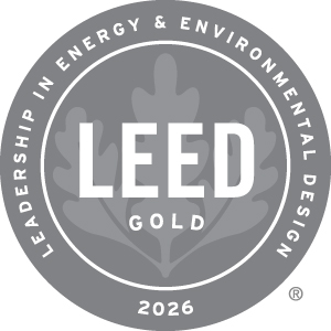 Gray circular LEED Gold certification emblem for 2026, featuring a leaf design and the words “Leadership in Energy & Environmental Design” surrounding “LEED Gold.”
